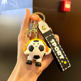 Breloc Flippy din acril negru, design minge de fotbal cu căști, detaliu cureluță prindere