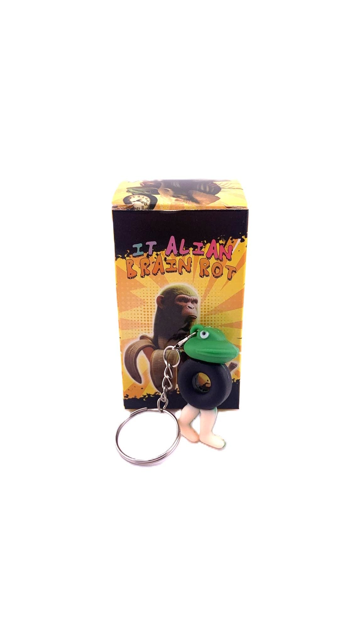 Breloc de Chei din Silicon, Flippy, Figurina Brainrot Broscuta cu Anvelopa Boneca Ambalabu, 4 cm, Negru/Verde - vivimall.ro